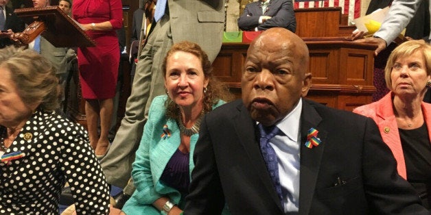 This photo provided by Rep. Chillie Pingree,D-Maine, shows Democrat members of Congress, including Rep. John Lewis, D-Ga., center, and Rep. Elizabeth Esty, D-Conn. as they participate in sit-down protest seeking a a vote on gun control measures, Wednesday, June 22, 2016, on the floor of the House on Capitol Hill in Washington. (Rep. Chillie Pingree via AP)