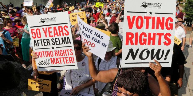 Demonstrators march through the streets of Winston-Salem, N.C., Monday, July 13, 2015, after the beginning of a federal voting rights trial challenging a 2013 state law. Election law experts say the case could determine how far Southern states can change voting rules after the nation's highest court struck down a portion of the federal Voting Rights Act just weeks before the North Carolina law was passed. (AP Photo/Chuck Burton)