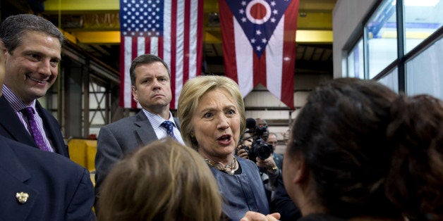 Democratic presidential candidate Hillary Clinton, joined by Rep. Tim Ryan, D-Ohio., left, greets people in the audience during a campaign event at M-7 Technologies in Youngstown, Ohio, Saturday, March 12, 2016. (AP Photo/Carolyn Kaster)