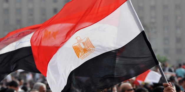 An Egyptian flag is held above in Cairo's Tahrir Square at a rally two weeks after the resignation of President Mubarak.