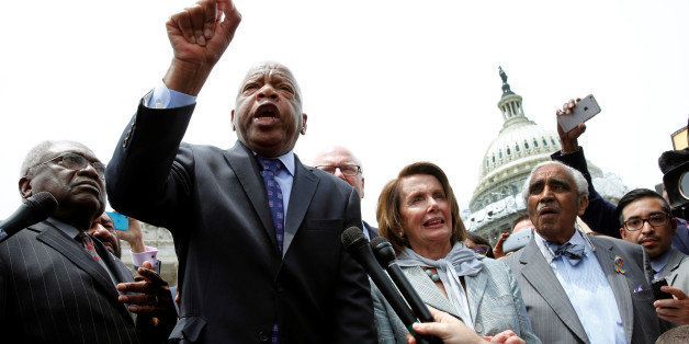 U.S. Rep. John Lewis (D-GA) (2nd L) talks to supporters along with House Democrats after their sit-in over gun-control law on Capitol Hill in Washington, U.S., June 23, 2016. REUTERS/Yuri Gripas 