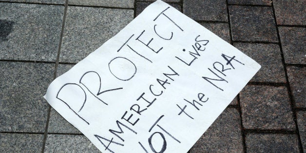 A poster for the gun-control law support is left on the ground on Capitol Hill in Washington, U.S., June 23, 2016. REUTERS/Yuri Gripas 