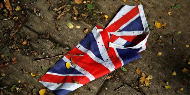 A British flag which was washed away by heavy rains the day before lies on the street in London, Britain, June 24, 2016 after Britain voted to leave the European Union in the EU BREXIT referendum. REUTERS/Reinhard Krause