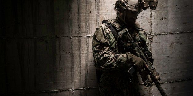 A combat ready special operation forces soldier with a MP7 silenced submachine gun and a night vision google.