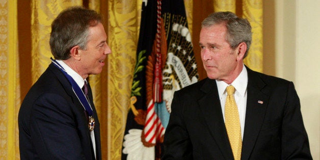 Former British Prime Minister Tony Blair (L) receives the Presidential Medal of Freedom from U.S. President George W. Bush during a ceremony in the East Room of the White House in Washington, January 13, 2009. The award is the highest civilian honour that is given in the United States. REUTERS/Jason Reed (UNITED STATES)