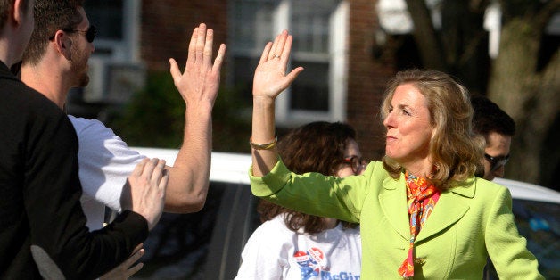 Katie McGinty greets supporters with high-fives as she arrives at her polling station to cast her vote Tuesday, April 26, 2016 in Wayne, Pa. Former Congressman Joe Sestak looks to hold off McGinty, the party-endorsed candidate, and win the Democratic nomination for U.S. Senate, setting up a rematch with the Republican incumbent Pat Toomey. (AP Photo/Jacqueline Larma)