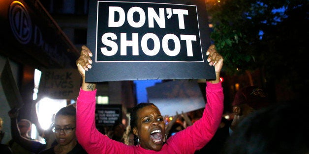 TOPSHOT - A woman holds a banner during a protest in support of the Black lives matter movement in New York on July 09, 2016. The gunman behind a sniper-style attack in Dallas was an Army veteran and loner driven to exact revenge on white officers after the recent deaths of two black men at the hands of police, authorities have said. Micah Johnson, 25, had no criminal history, Dallas police said in a statement. / AFP / KENA BETANCUR (Photo credit should read KENA BETANCUR/AFP/Getty Images)