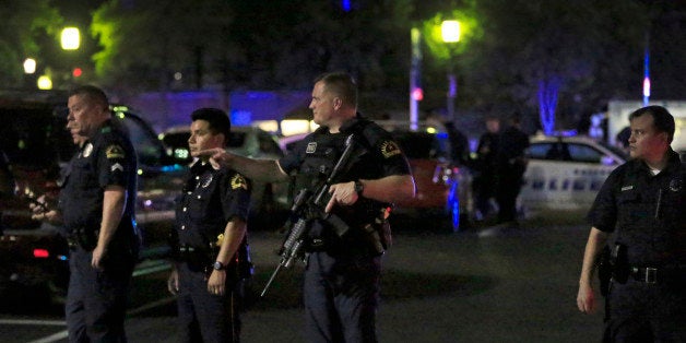 DALLAS, TX - JULY 7: Dallas police stand watch near the scene where four Dallas police officers were shot and killed on July 7, 2016 in Dallas, Texas. According to reports, shots were fired during a protest being held in downtown Dallas in response to recent fatal shootings of two black men by police - Alton Sterling on July 5, 2016 in Baton Rouge, Louisiana and Philando Castile on July 6, 2016, in Falcon Heights, Minnesota. (Photo by Ron Jenkins/Getty Images)