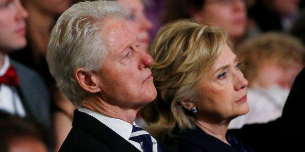 NEW YORK, NY - MAY 15: (L-R) Former U.S. president Bill Clinton and former U.S. Secretary of State Hillary Clinton attend the opening ceremony for the National September 11 Memorial Museum at ground zero May 15, 2014 in New York City. The museum spans seven stories, mostly underground, and contains artifacts from the attack on the World Trade Center Towers on September 11, 2001 that include the 80 ft high tridents, the so-called 'Ground Zero Cross,' the destroyed remains of Company 21's New York Fire Department Engine as well as smaller items such as letter that fell from a hijacked plane and posters of missing loved ones projected onto the wall of the museum. The museum will open to the public on May 21. (Photo by Mike Segar-Pool/Getty Images)