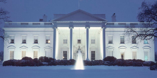 A day long snowstorm covered the North Lawn of the White House, reflecting some of the blue evening sky.