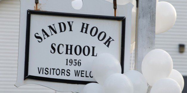 Balloons hang on a sign at the entrance to Sandy Hook School on December 15, 2012 in Newtown, Connecticut. The residents of an idyllic Connecticut town were reeling in horror from the massacre of 20 small children and six adults in one of the worst school shootings in US history. The heavily armed gunman shot dead 18 children inside Sandy Hook Elementary School, said Connecticut State Police spokesman Lieutenant Paul Vance. Two more died of their wounds in hospital. AFP PHOTO/DON EMMERT (Photo credit should read DON EMMERT/AFP/Getty Images)