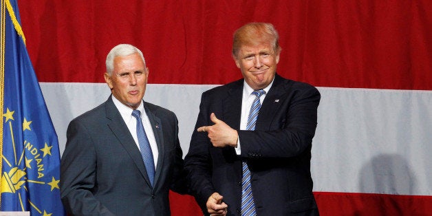 Republican U.S. presidential candidate Donald Trump (R) points to Indiana Governor Mike Pence (L) before addressing the crowd