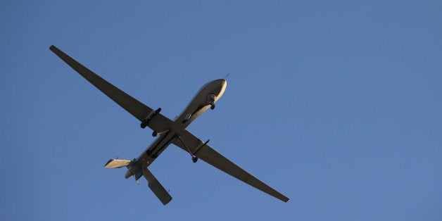 UNSPECIFIED, UNSPECIFIED - JANUARY 07: A U.S. Air Force MQ-1B Predator unmanned aerial vehicle (UAV), carrying a Hellfire missile flies over an air base after flying a mission in the Persian Gulf region on January 7, 2016. The U.S. military and coalition forces use the base, located in an undisclosed location, to launch airstrikes against ISIL in Iraq and Syria, as well as to distribute cargo and transport troops supporting Operation Inherent Resolve. The Predators at the base are operated and maintained by the 46th Expeditionary Reconnaissance Squadron, currently attached to the 386th Air Expeditionary Wing. (Photo by John Moore/Getty Images)