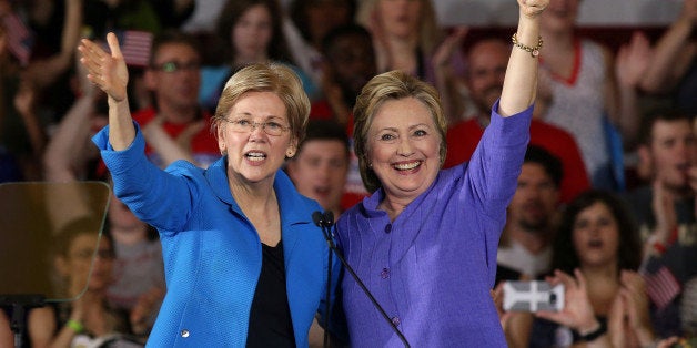 Democratic U.S. presidential candidate Hillary Clinton (R) stands along side US Senator Elizabeth Warren at a campaign rally