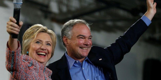 Democratic U.S. presidential candidate Hillary Clinton and U.S. Senator Tim Kaine (D-VA) wave to the crowd during a campaign rally at Ernst Community Cultural Center in Annandale, Virginia, U.S., July 14, 2016. REUTERS/Carlos Barria