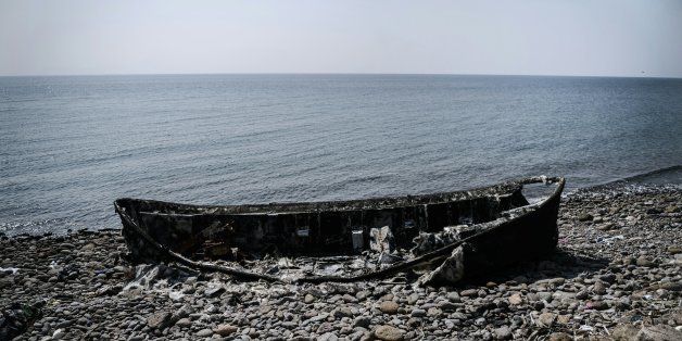 A picture shows a burnt boat and belongings left by migrants heading to the Greek island of Lesbos are seen on March 21, 2016 in the Kucukkuyu district of Canakkale, northwestern Turkey. / AFP / OZAN KOSE (Photo credit should read OZAN KOSE/AFP/Getty Images)