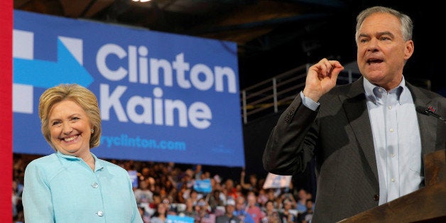 U.S. Democratic presidential candidate Hillary Clinton reacts as Democratic vice presidential candidate Senator Tim Kaine speaks at a campaign rally in Miami, Florida, U.S. July 23, 2016. REUTERS/Brian Snyder