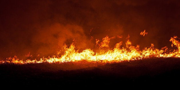 Burning dry grass at night