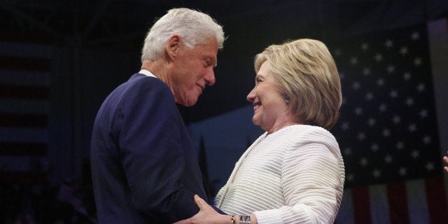 Democratic U.S. presidential candidate Hillary Clinton stands onstage with her husband former President Bill Clinton (L) after speaking during her California primary night rally held in the Brooklyn borough of New York, U.S., June 7, 2016. REUTERS/Shannon Stapleton