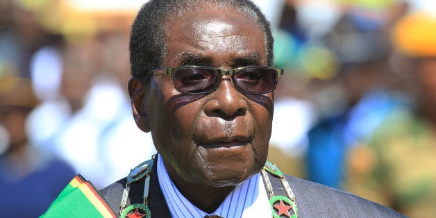 Zimbabwean President Robert Mugabe inspects the guard of honour during a ceremony in Harare, Monday Aug. 10, 2015, honouring