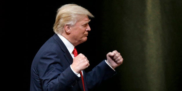 Republican Presidential candidate Donald Trump pumps his fists during a rally in Raleigh, N.C., Tuesday, July 5, 2016. (AP Photo/Gerry Broome)