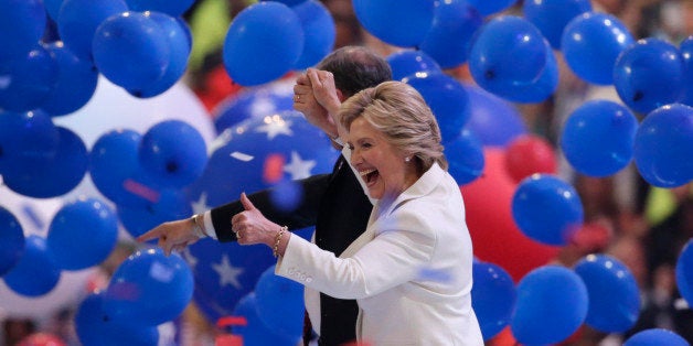 Democratic presidential nominee Hillary Clinton enjoys the balloon drop with her vice presidential running mate Senator Tim Kaine after accepting the nomination on the fourth and final night at the Democratic National Convention in Philadelphia, Pennsylvania, U.S. July 28, 2016. REUTERS/Gary Cameron