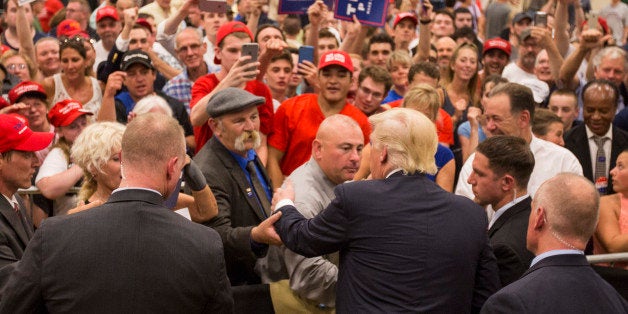 WINDHAM, NH - AUGUST 06: Republican presidential candidate Donald Trump works the role line follwing a rally at Windham High