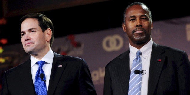 Republican U.S. presidential candidates Marco Rubio (L) and Ben Carson wait for the start of the Presidential Family Forum in