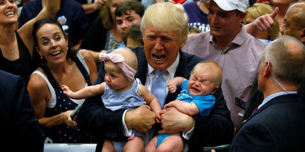 Republican presidential nominee Donald Trump holds babies at a campaign rally in Colorado Springs, Colorado, U.S., July 29, 2