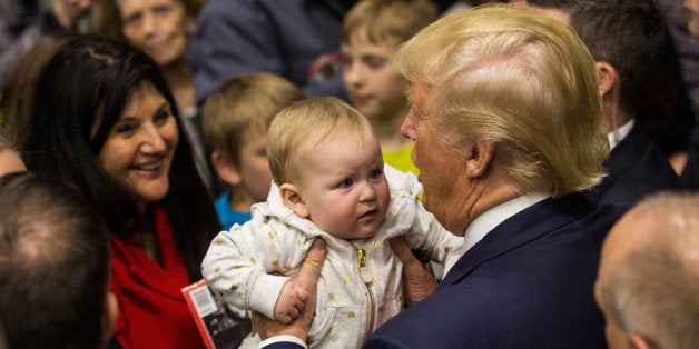 PORTSMOUTH, NH - FEBRUARY 04: Republican presidential hopeful Donald Trump holds a baby the end of a rally at Great Bay Comm