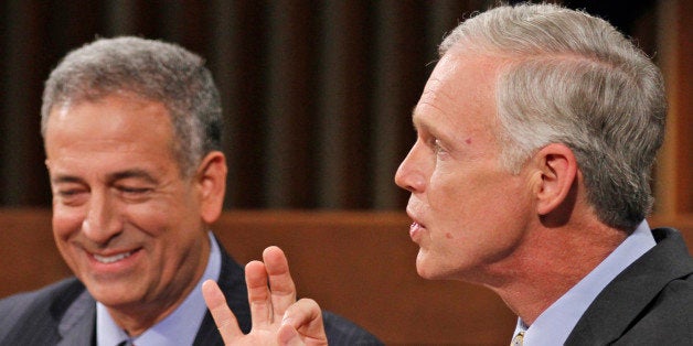 Wisconsin's Democratic candidate U.S. Senator Russ Feingold, left, listens as Republican challenger Ron Johnson, right, speaks during a senate debate held at Marquette University Law School, Friday, Oct. 22, 2010, in Milwaukee. (AP Photo/Jeffrey Phelps)