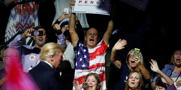 Supporters cheer as Republican presidential nominee Donald Trump takes the stage during a campaign rally in Jackson, Mississi