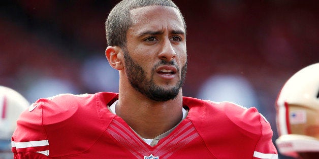 San Francisco 49ers quarterback Colin Kaepernick stands on the field before their NFL pre-season football game against the Denver Broncos in San Francisco, California, U.S. August 8, 2013. REUTERS/Stephen Lam/File Photo