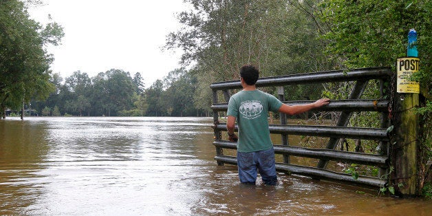 Nick George stands in the Tangipahoa River after Hurricane Isaac passed through Kentwood, Louisiana, August 30, 2012. Louisiana officials on Thursday ordered a widespread evacuation along the Tangipahoa River between the towns of Kentwood and Robert due to the imminent failure of a dam in Mississippi caused by rising water from the hurricane. REUTERS/Jonathan Bachman (UNITED STATES - Tags: ENVIRONMENT DISASTER)