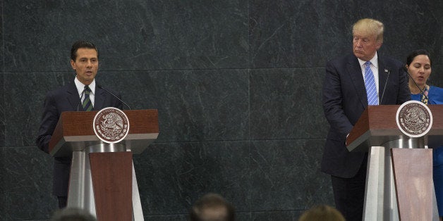 Enrique Pena Nieto, Mexico's president, left, speaks as Donald Trump, 2016 Republican presidential nominee, listens during a joint conference in Mexico City, Mexico, on Wednesday, Aug. 31, 2016. The meeting of Trump and Pena Nieto will address economics, jobs, Mexican drug cartels, the flow of drugs, cash and arms, and the positioning of the Western hemisphere toward Asia, including the challenges that a rising China poses to both Mexico and the United States. Photographer: Susana Gonzalez/Bloomberg via Getty Images