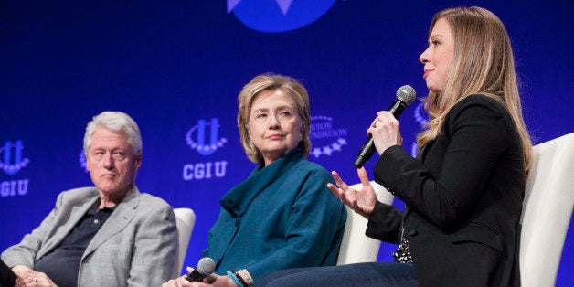 Former President Bill Clinton (L) and former Secretary of State Hillary Clinton (C) listen to their daughter and Vice Chair of the Clinton Foundation Chelsea Clinton during the second day of the 2014 Meeting of the Clinton Global Initiative at Arizona State University in Tempe, Arizona March 22, 2014. REUTERS/Samantha Sais (UNITED STATES - Tags: POLITICS)