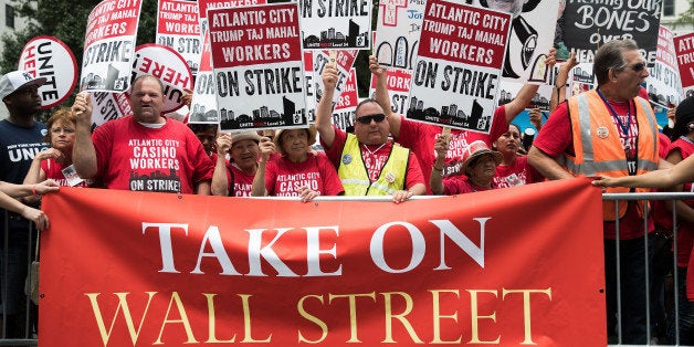 NEW YORK, NY - JULY 13: Casino workers and activists protest outside Trump Taj Mahal owner Carl Icahn's office on Fifth Avenu