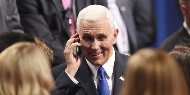 Republican vice presidential candidate Mike Pence speaks on his cell phone following the US vice presidential debate at Longw