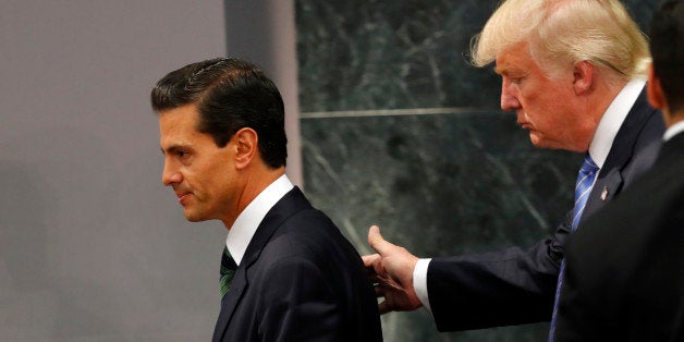 Republican presidential nominee Donald Trump walks with Mexico President Enrique Pena Nieto at the end of their joint stateme