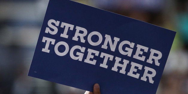 PHILADELPHIA, PA - JULY 25: A delegate holds a sign that reads 'Stronger together' on the first day of the Democratic National Convention at the Wells Fargo Center, July 25, 2016 in Philadelphia, Pennsylvania. An estimated 50,000 people are expected in Philadelphia, including hundreds of protesters and members of the media. The four-day Democratic National Convention kicked off July 25. (Photo by Jessica Kourkounis/Getty Images)