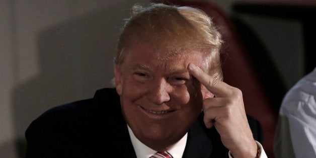 Republican presidential nominee Donald Trump smiles as he meets with local labor leaders and union members during a campaign
