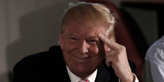 Republican presidential nominee Donald Trump smiles as he meets with local labor leaders and union members during a campaign stop in Brook Park, Ohio, U.S. September 5, 2016. REUTERS/Mike Segar