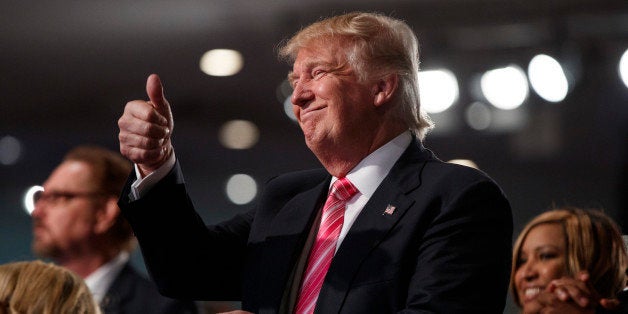 Republican presidential candidate Donald Trump gives a thumbs up during a church service at Great Faith Ministries, Saturday,