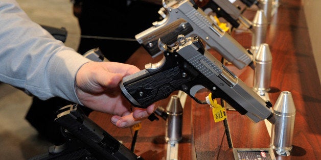 LAS VEGAS, NV - JANUARY 17: Attendees try out Sig Sauer 1911 model pistols at the Sig Sauer booth at the National Shooting S