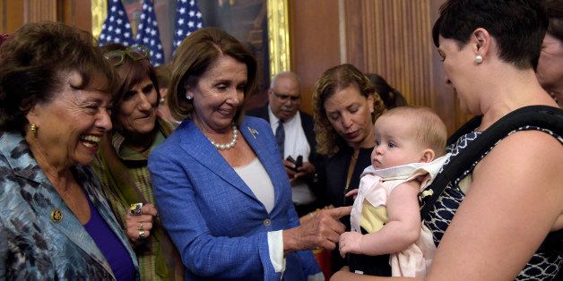 Emily J. Holubowich, right, holds her daughter Jackie, as she talks with, from left, Rep. Nita Lowey, D-N.Y., Rep. Rosa DeLauro, D-N.Y., House Minority Leader Nancy Pelosi of Calif., and Rep. Debbie Wasserman-Schultz, D-Fla., following a news conference about the Zika virus on Capitol Hill in Washington, Wednesday, Sept. 7, 2016. (AP Photo/Susan Walsh)