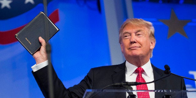 Donald Trump, president and chief executive of Trump Organization Inc. and 2016 Republican presidential candidate, holds up a Bible while speaking at the Values Voter Summit in Washington, D.C., U.S., on Friday, Sept. 25, 2015. The annual event, organized by the Family Research Council, gives presidential contenders a chance to address a conservative Christian audience in the crowded Republican primary contest. Photographer: Drew Angerer/Bloomberg via Getty Images