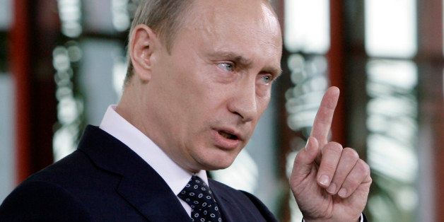 Russia's President Vladmir Putin gestures, during a joint news conference with Italy's Premier-elect Silvio Berlusconi (not visible), after talks in Berlusconi's Villa Certosa, in Porto Rotondo, on the island region of Sardinia, Italy, Friday, April 18, 2008. (AP Photo/Luca Bruno)