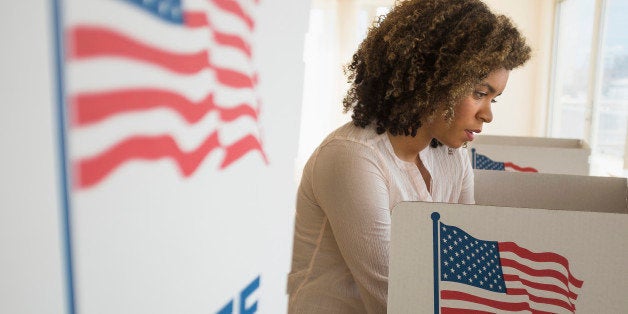 Young woman preparing voting booth