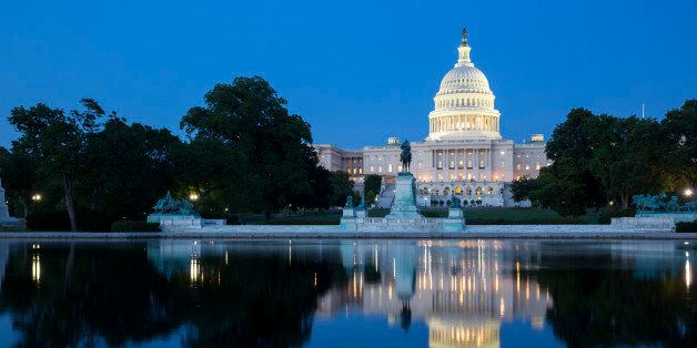 The Capitol Building and Reflecting Pool in Washington D.C. America, illuminated at night.