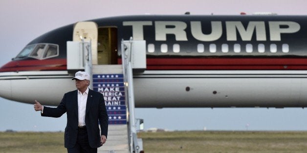 Republican presidential nominee Donald Trump walks across the tarmac as he arrives for a rally at the JetCenters of Colorado